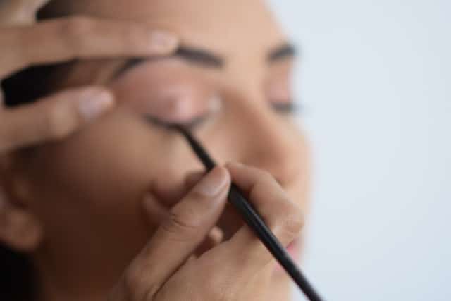 A woman applying make up